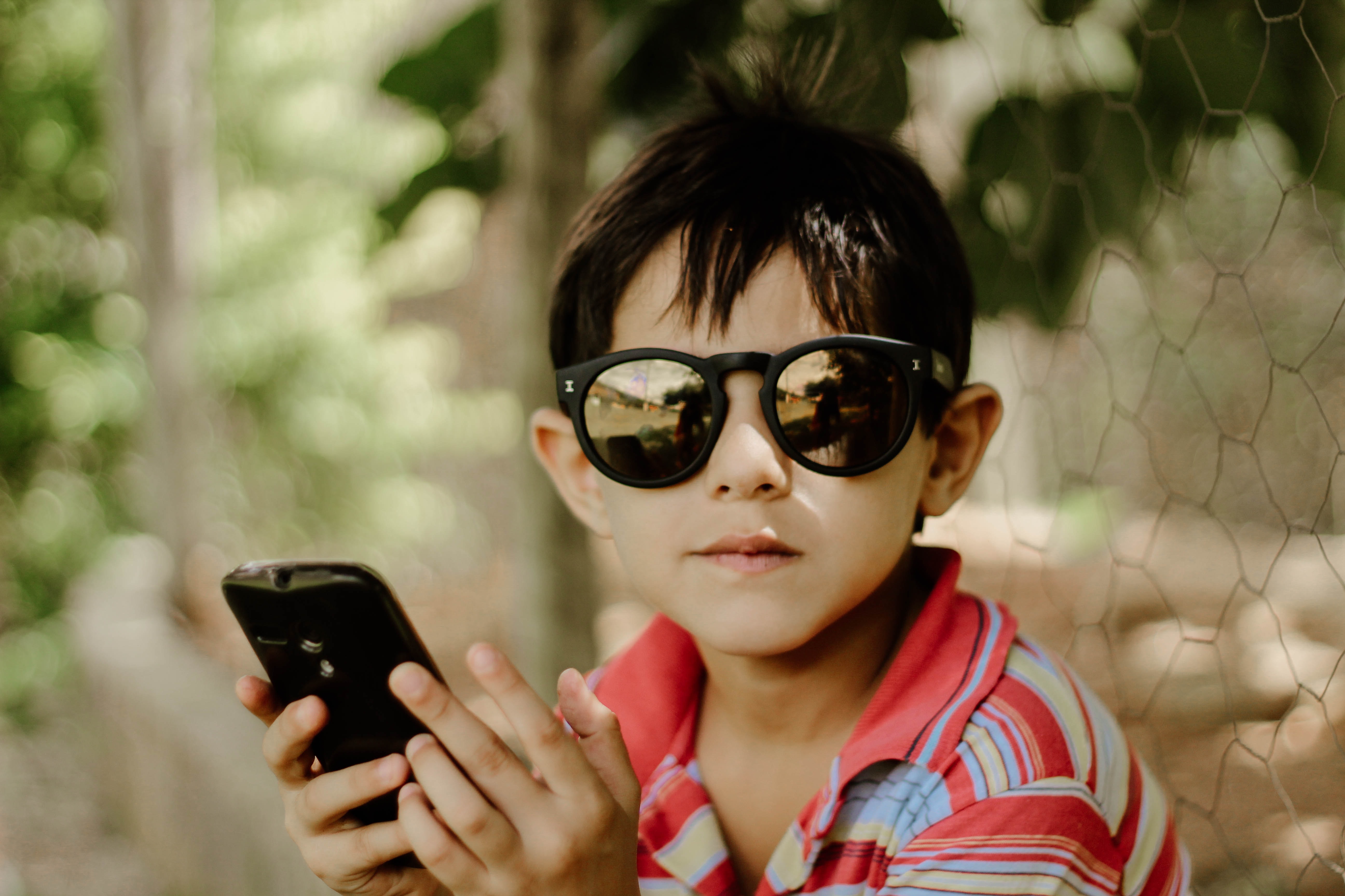A young boy in sunglasses who is getting ready to start his Class A young boy in sunglasses who is getting ready to start his Class